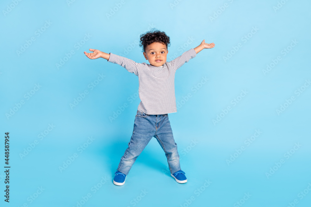 Full length body size view of attractive kind boy giving big hug isolated over vibrant blue color background Full length body size view of attractive kind boy giving big hug isolated over vibrant blue color background