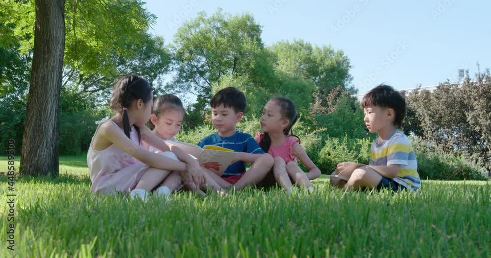 Children reading book on meadow,4K Children reading book on meadow,4K