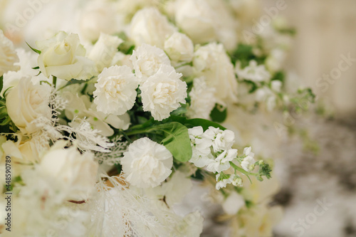 Beautiful white and green floral decoration on wedding table in restauratnt