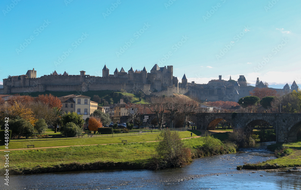 Fototapeta premium River with a stone bridge and a castle in the background