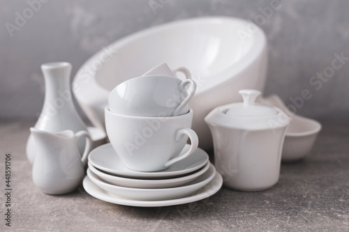 Empty crockery set or white ceramic dishes. White kitchen dishware and tableware on table © Sergii Moscaliuk