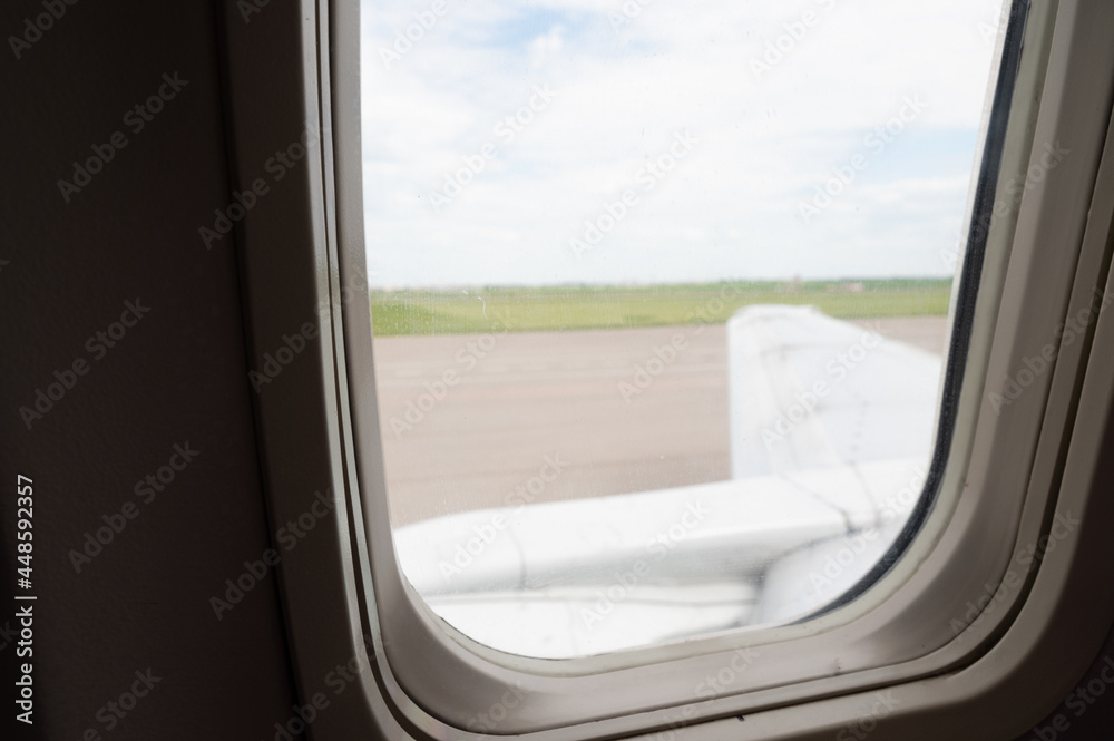Wing of an aircraft in the aluminator window