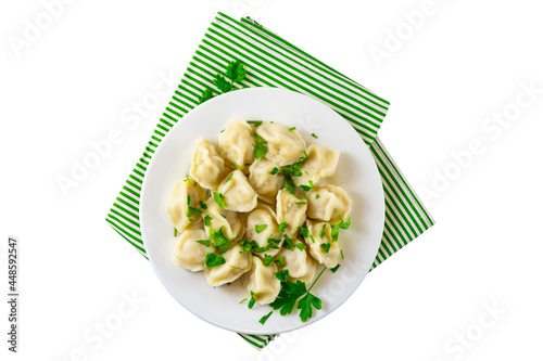 Traditional Russian food homemade dumplings.Ravioli, dumplings with meat filling on a white plate, isolated on a white background, top view