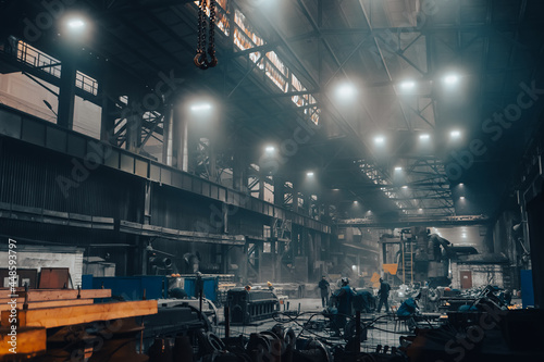 Industrial heavy industry workshop or warehouse with steel goods and workers on metallurgical factory.