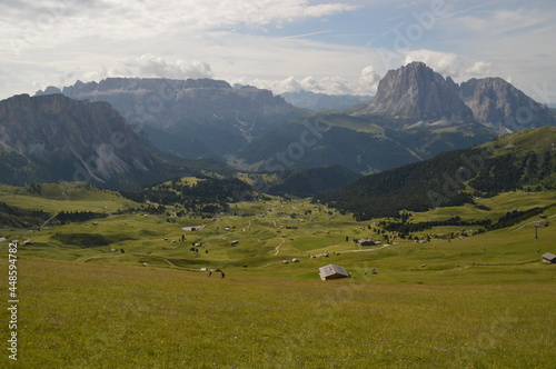 Taking in the stunning mountain views from a steep ridge in the Dolomites 