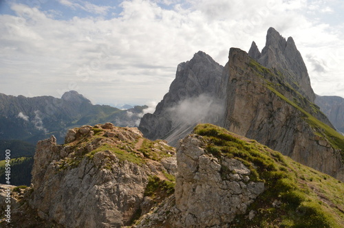 Taking in the stunning mountain views from a steep ridge in the Dolomites 