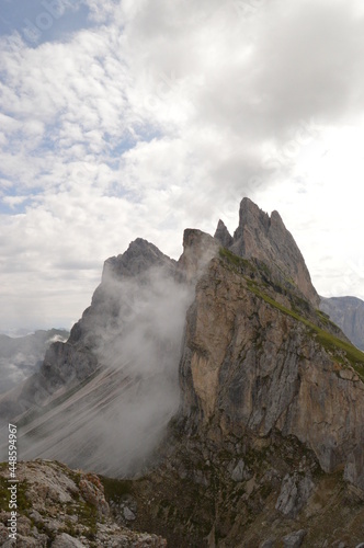Taking in the stunning mountain views from a steep ridge in the Dolomites 