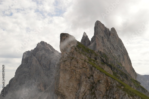 Taking in the stunning mountain views from a steep ridge in the Dolomites 