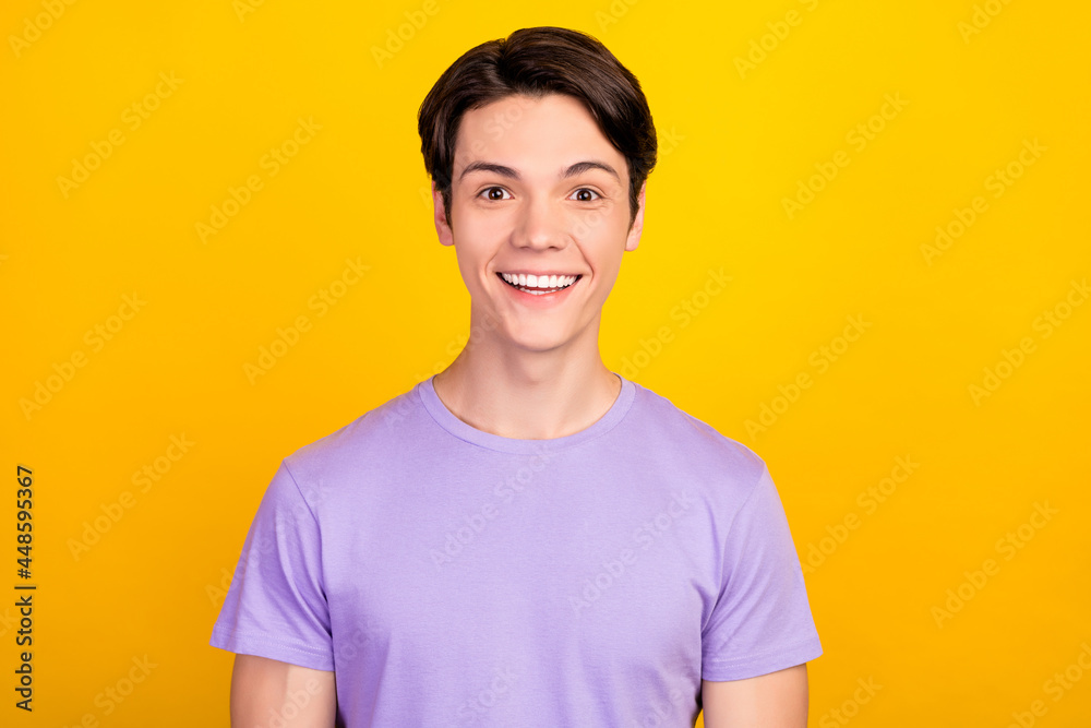 Portrait of attractive cheerful amazed guy good news sincere reaction isolated over bright yellow color background Portrait of attractive cheerful amazed guy good news sincere reaction isolated over bright yellow color background