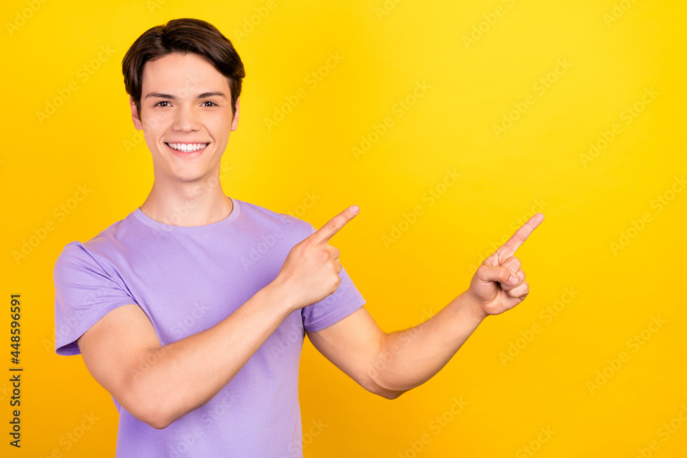 Portrait of attractive cheerful guy demonstrating copy empty space place offer ad isolated over bright yellow color background Portrait of attractive cheerful guy demonstrating copy empty space place offer ad isolated over bright yellow color background