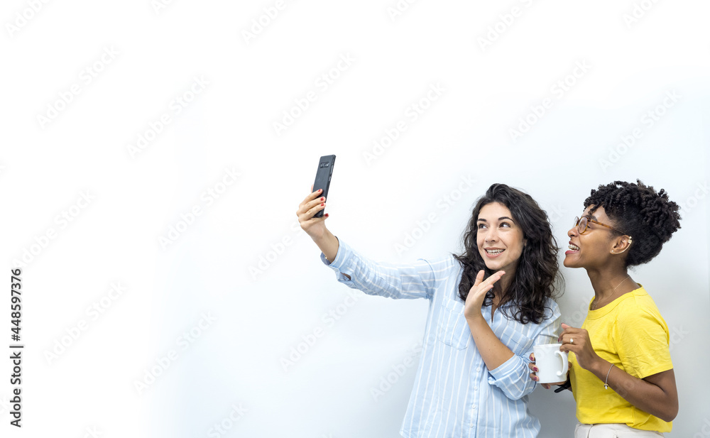 two beautiful young woman taking selfie at office