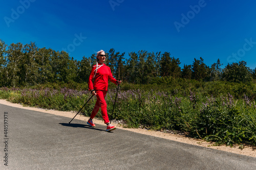 an elderly woman with Nordic walking sticks