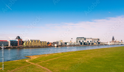 Cologne Koln, Germany, Panorama view of the Rhine River with Siebengebirge and Kranhaus Buildings, and Cathedral on Rheinauhafen photo