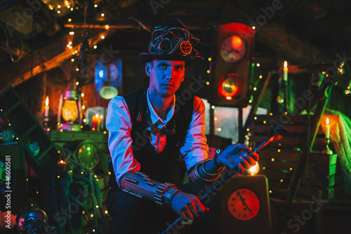 male inventor in a steampunk suit, top hat, glasses with a cane in his hand in a watch workshop