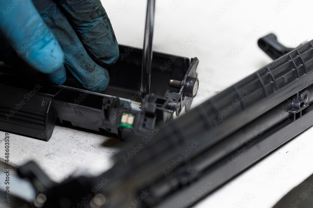 Disassembly of the toner cartridge for refilling. Restoration and maintenance in the service center of the printing device.
