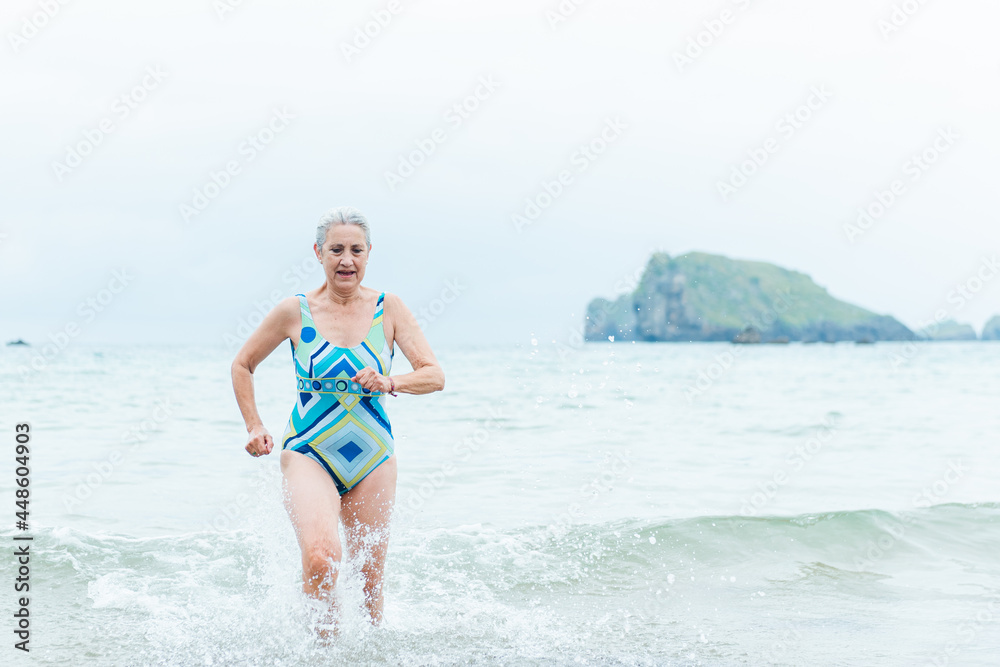 Happy senior woman bathing in ocean Happy senior woman bathing in ocean