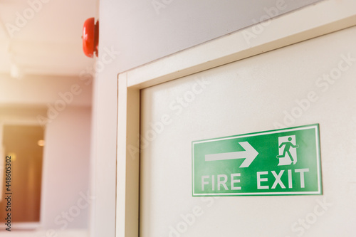 Emergency Fire exit door with alarm bell in condominium and commercial building. photo