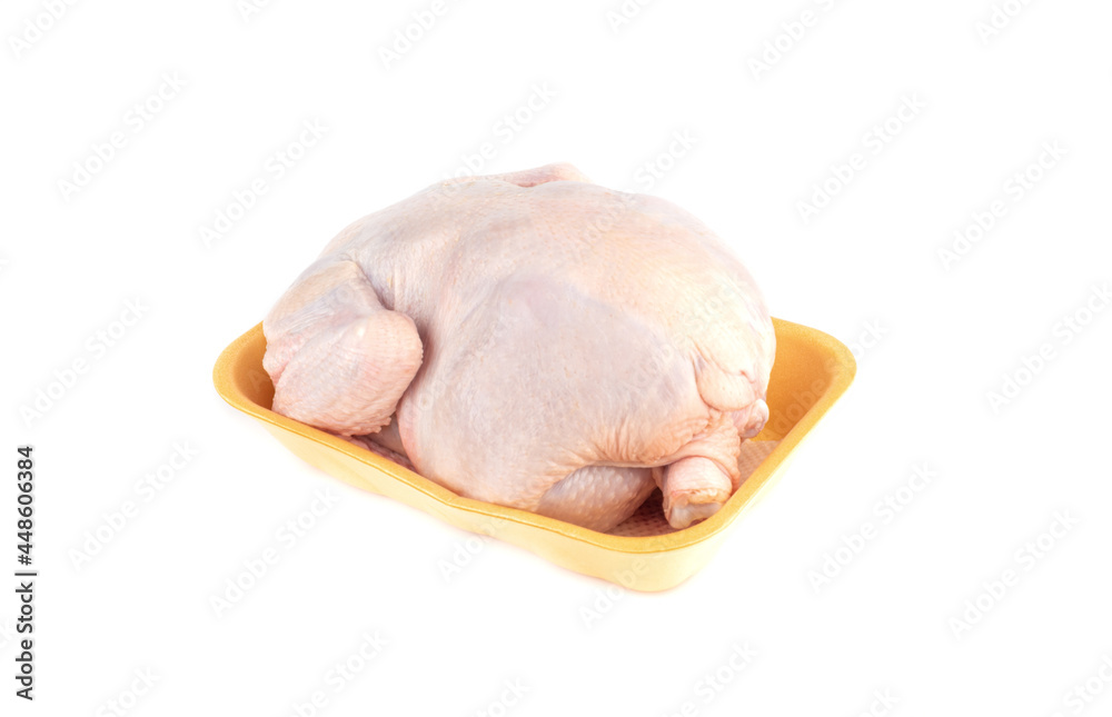 Raw whole fresh chicken carcass in a plastic tray over white background. Raw whole fresh chicken carcass in a plastic tray over white background.