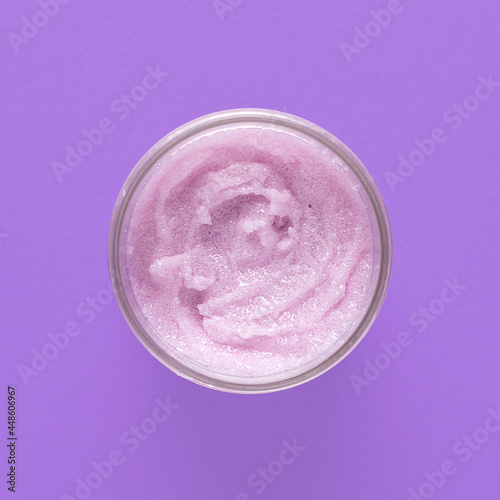 Cosmetic scrub for face and body on a lilac background. Beauty concept. Body treatment. Skin care.Top view. Selective focus.