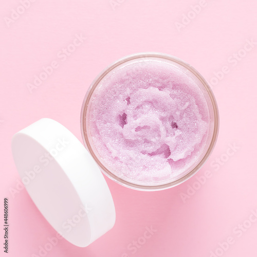 Cosmetic scrub for face and body on a pink background. Beauty concept. Body treatment. Skin care. Top view. Flat lay.