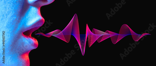 Woman lips with sound wave on black background in neon light. photo