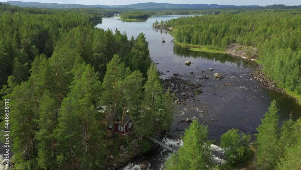 Aerial view of a red cabin on an island in Jamtland, Sweden Aerial view of a red cabin on an island in Jamtland, Sweden