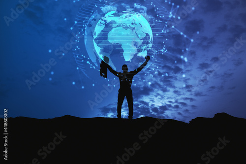 Backlit businessman holding glowing earth hologram on dark night city background. Global future and digital transformation concept.
