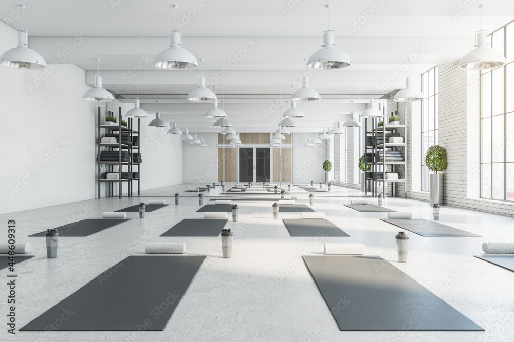 Contemporary bright white yoga studio gym interior with brick wall ...