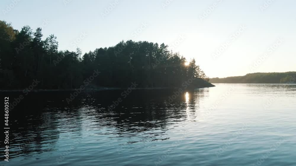 landscape with colorful kayaks by rocky bank of large tranquil river near island covered with pine forest aerial motion landscape with colorful kayaks by rocky bank of large tranquil river near island covered with pine forest aerial motion