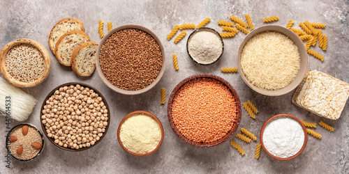Selection of gluten free food. A variety of grains, flours, pasta, and bread gluten-free on a rustic background. Top view, flat lay,wide composition.