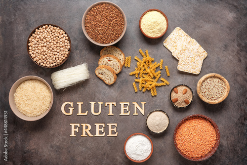 Selection of gluten free food on a brown grunge background. A variety of grains, flours, pasta, and bread gluten-free. Top view, flat lay. © Yulia