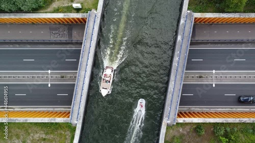 Aerial top down view of a road aquaduct or aqueduct is structure used to conduct water across two places in this case modern engineering to connect a lake over a highway like a water-bridge 4k quality photo