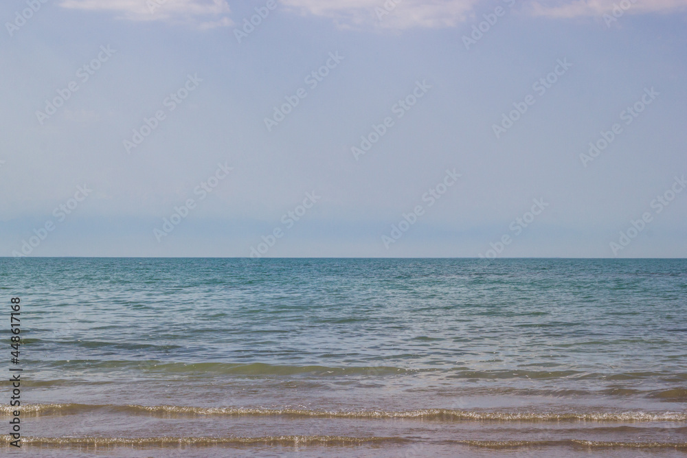 Morning scenery lakeside scenery: coastline, summer sky and waving water of the lake