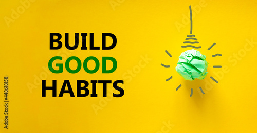 Build good habits symbol. Green shining light bulb icon. Words 'Build good habits'. Beautiful yellow background. Business, psychology and build good habits concept. Copy space. photo