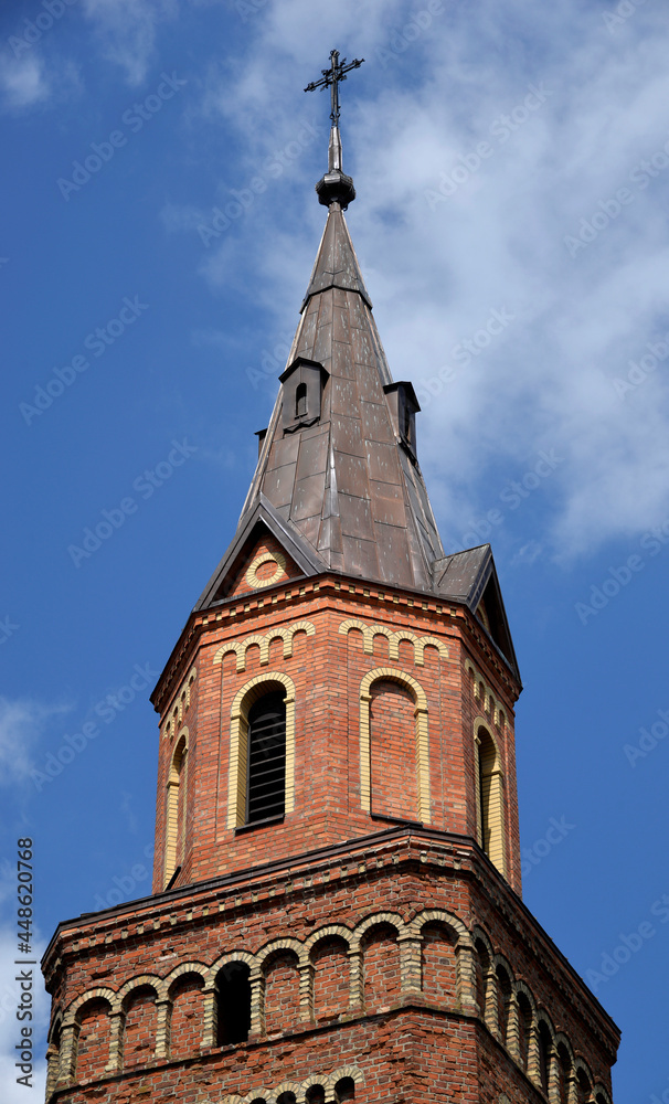 Obraz premium A brick chapel and a Roman Catholic church of St. Michael the Archangel built at the turn of the 19th and 20th centuries in Jabłonka Kościelna in Podlasie, Poland.