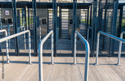 Metal railings in front of gates of Silesian Stadium in Chorzów, Poland. Row of steel rails. Entrance to the sport arena.