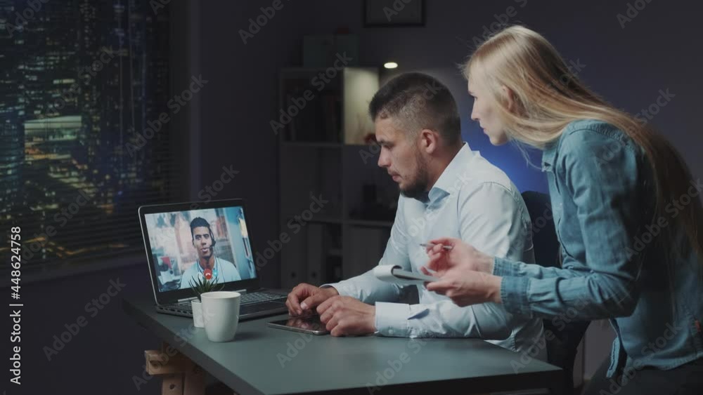 Mixed-race directors making video call while secretary reminding about next meeting. They working on the night shift.