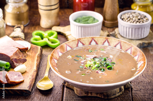 typical Brazilian bean broth, bean soup with bacon, pepperoni, green aroma, onion and chopped vegetables