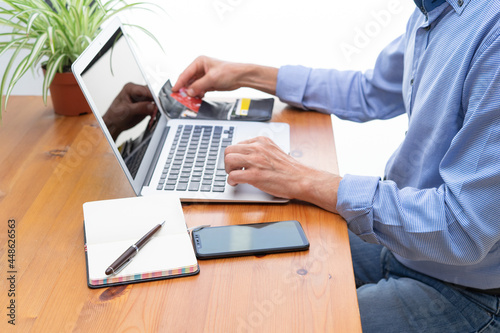 Man making online payments in front of the computer.