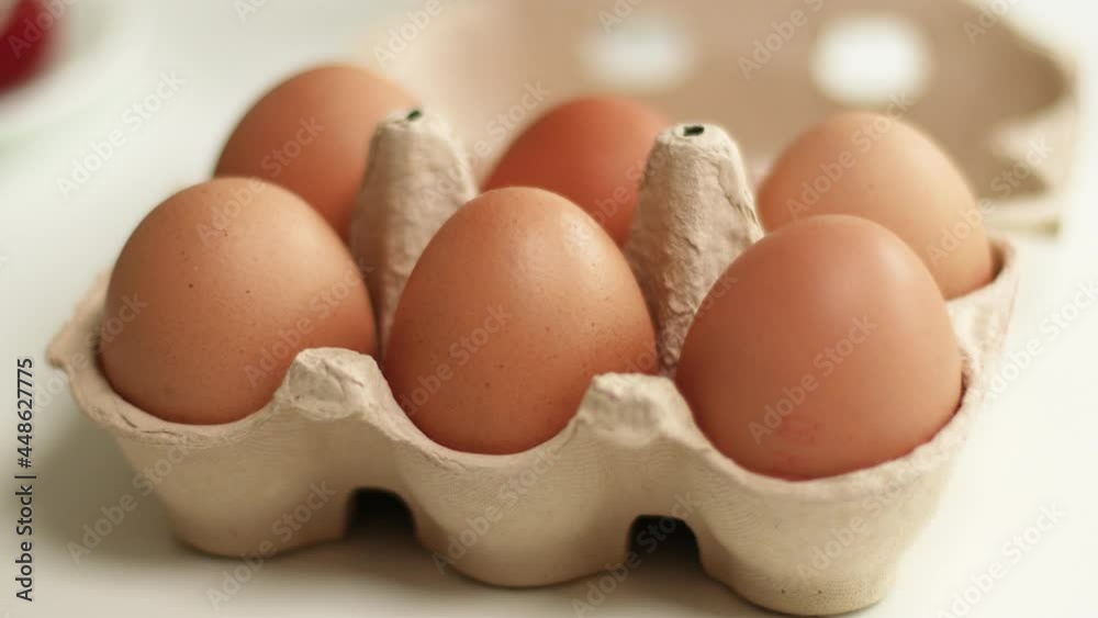 Easter Eggs in basket. Organic chicken eggs in a brown paper box placed on white table. Healthy food and organic protein breakfast concept