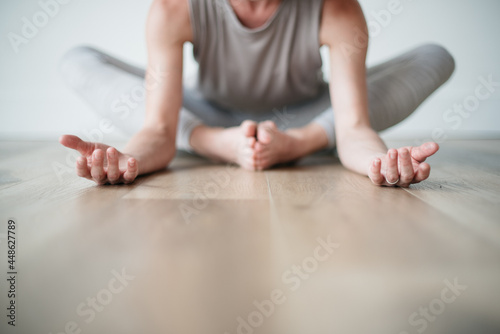 woman meditating holding yoga pose in studio