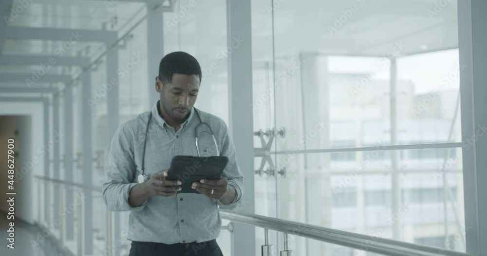 African American Doctor using a digital tablet in a hospital African American Doctor using a digital tablet in a hospital