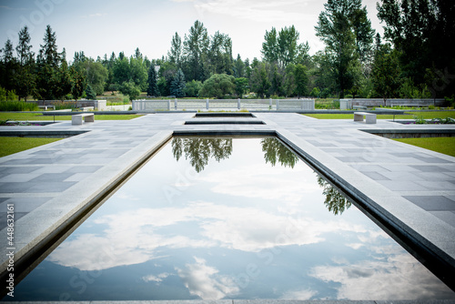 Tree and cloud reflection in the water feature at the new Aga Khan Garden, Devon Botanical Gardens, Devon, Alberta, Canada. photo