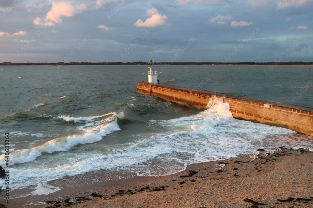Waves splashing on the pier at sunset
