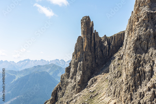 single mountain peak rising out on its own in the dolomite mountains