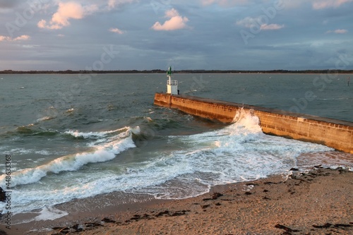 Waves splashing on the pier at sunset 