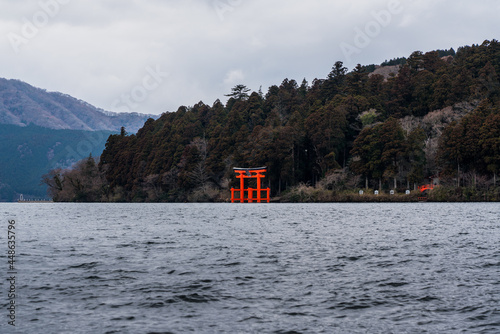 Lake Ashi with Hakone Jinjya Heiwa no Torii, red Shinto Shrine in the background. photo