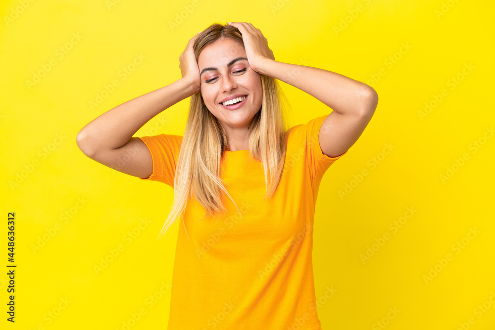 Blonde Uruguayan girl isolated on yellow background laughing Blonde Uruguayan girl isolated on yellow background laughing