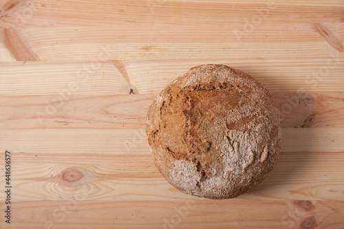 Handmade fresh wheat bread on wooden background in the morning light. horizontal frame top view with space area for text or design