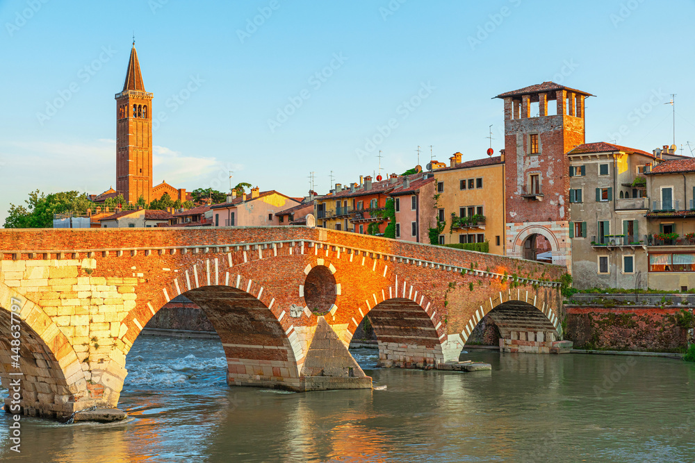 View on Bridge Ponte Pietra in Verona on Adige river, Veneto region, Italy. Summer morning landscape